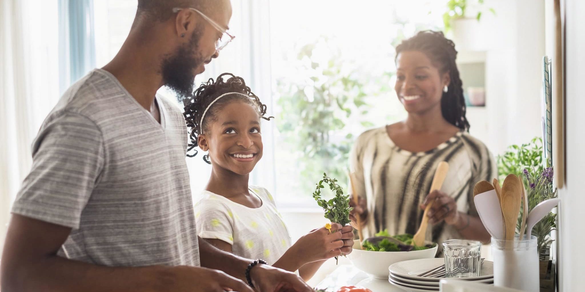 Black family cooking in kitchen